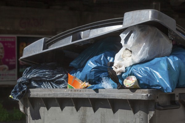 Overfilled rubbish container, Germany, Europe