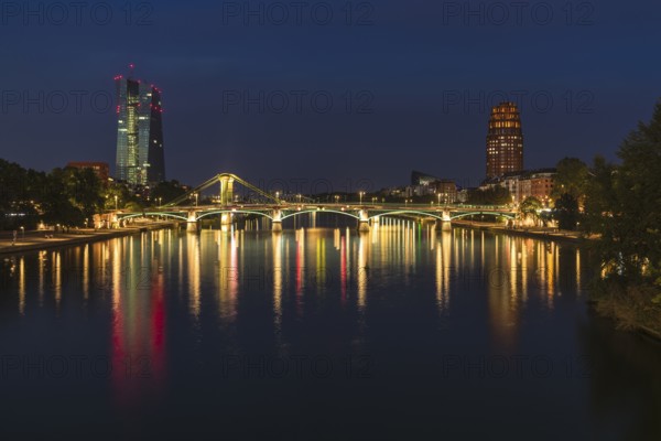 View at blue hour of the colourfully illuminated Flößerbrücke, the European Central Bank on the