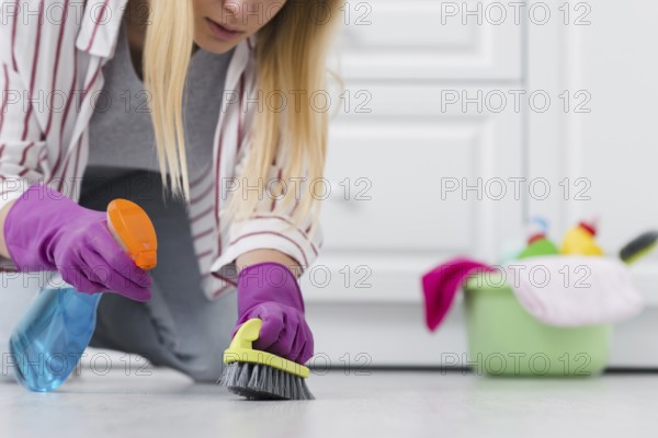 Close up woman spray cleaning floor. Resolution and high quality beautiful photo