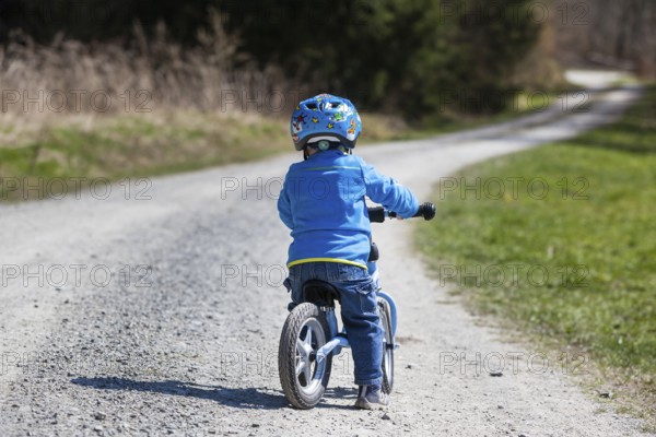 Child with a running bike