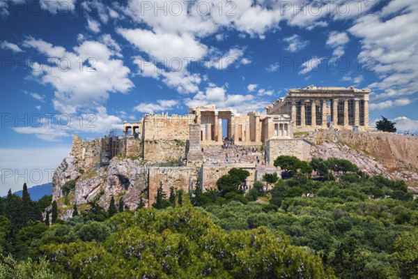 View of Acropolis hill with Propylaea and Parthenon in Athens, Greece from Pnyx hill in summer