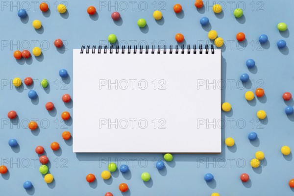 Top view colorful jelly beans with notebook