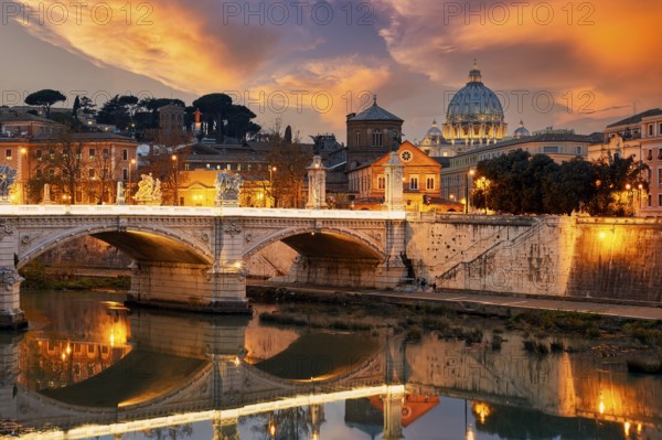 View of the Tiber River and Saint Peter's Basilica at sunset in Rome Italy