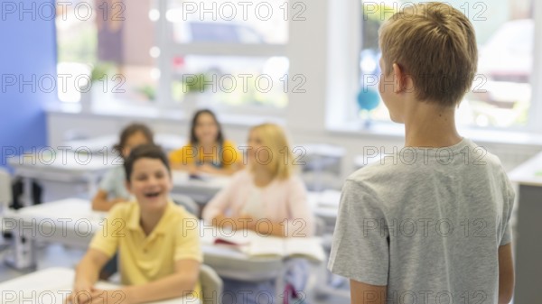 High angle boy presenting class