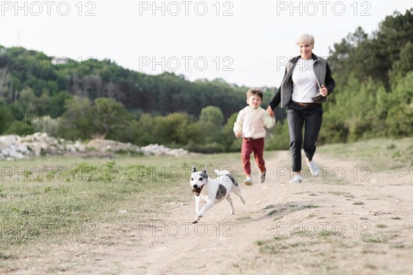Family enjoying walk park with dog