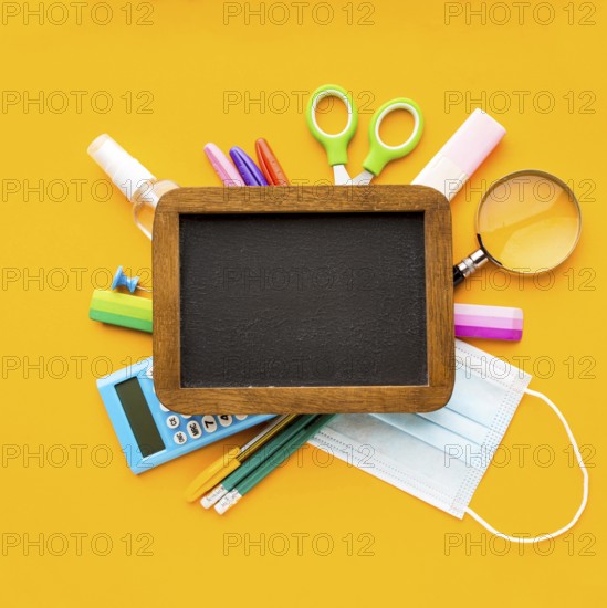 Top view back school essentials with blackboard pencils