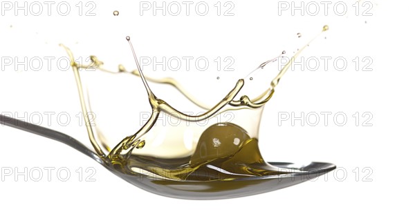 Olive Falling into Olive Oil against White Background