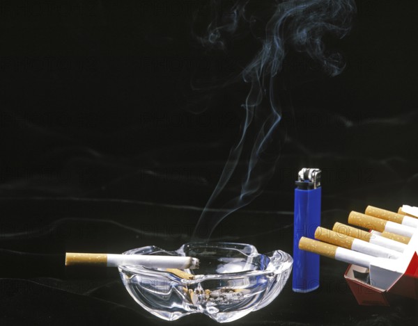 Cigarettes with Ashtray and Lighter against Black Background