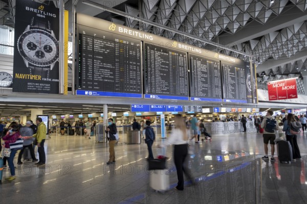 Frankfurt Airport, Fraport, Terminal 1 departure hall, passengers under a display panel, Frankfurt