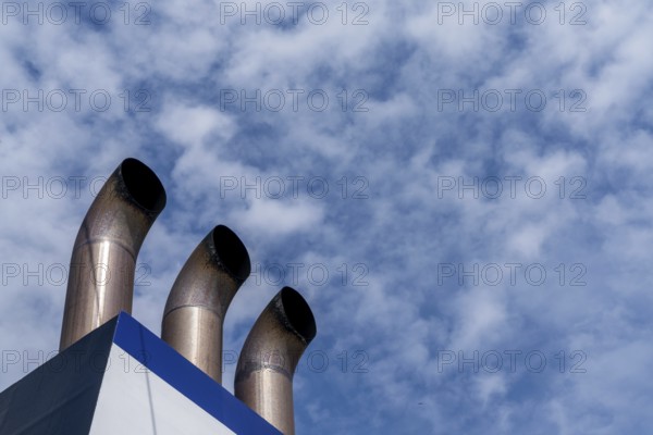 A detail view of three chimney smokestacks of a large passenger ferry