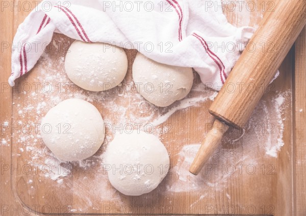 Yeast dough for making braided cakes, pies, pizza and rolls with rolling pin. Preparing leavened