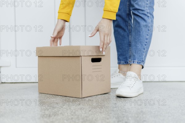 Close up hands lifting box