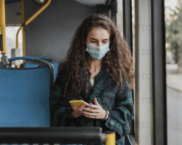 Woman with curly hair wearing medical mask front view