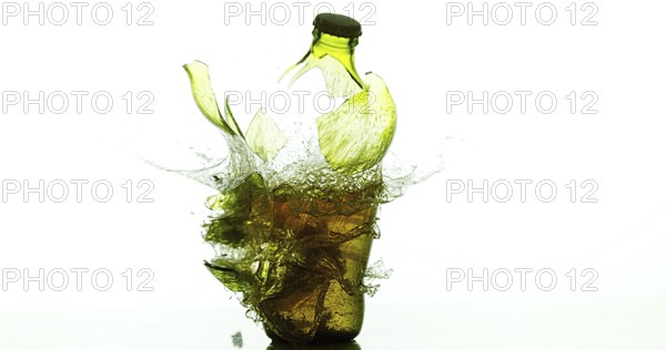 Bottle of Beer Breaking and Splashing against White Background