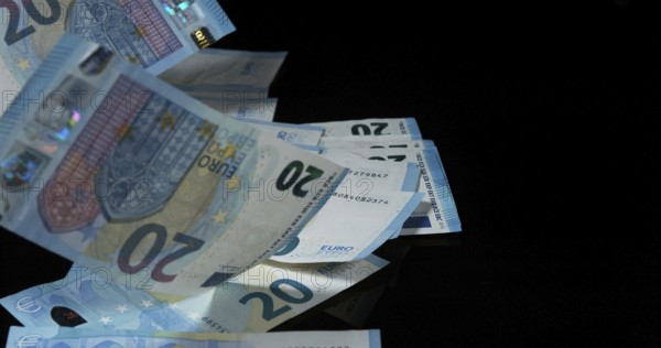 Euros Money Falling against Black Background