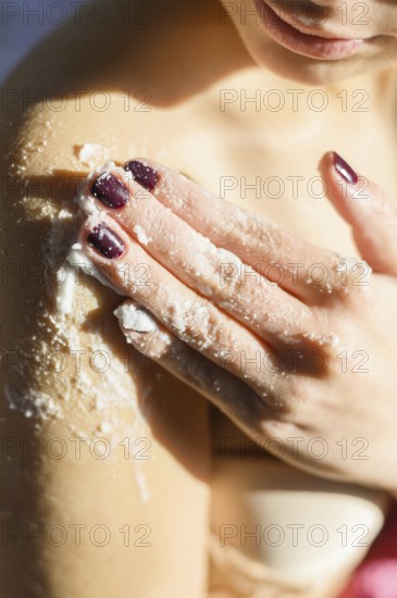 Woman applying body scrub her shoulder. Resolution and high quality beautiful photo