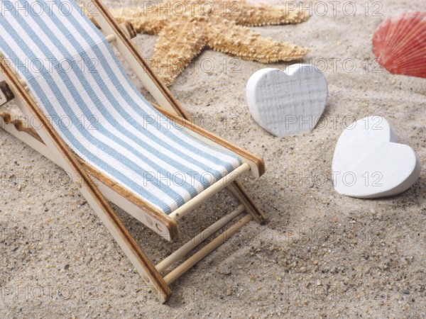 Blue deckchair with starfish in the sand on a beach