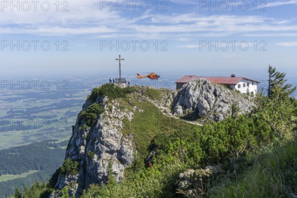Air rescue helicopter flies to Hochfelln mountain, Bergen, Chiemgau, Upper Bavaria, Germany, Europe