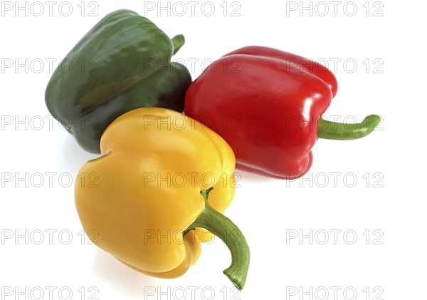 Red yellow and green peppers (capsicum) annuum, against white background