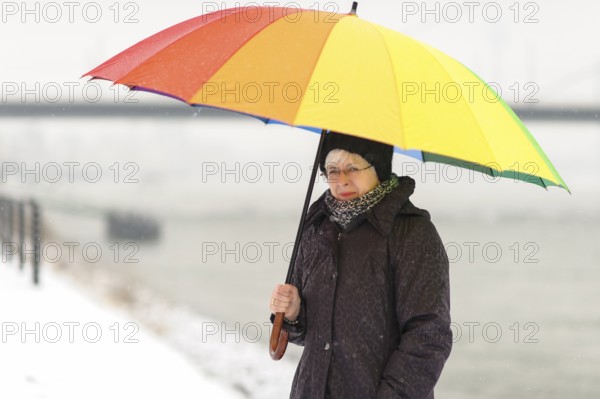 A woman in the snow with an umbrella