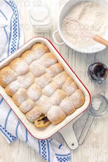 Sweet rolls, Buchteln filled with plum jam or jelly with backing ingredients