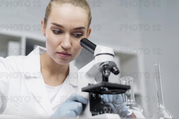 Female researcher laboratory with microscope