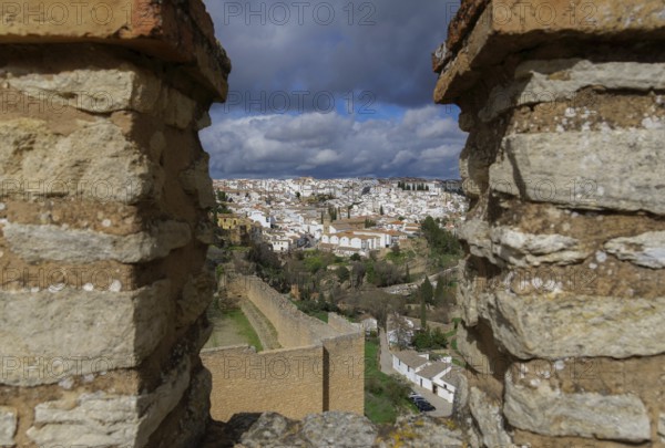 View of the city of ronda, malaga, spain from the city walls under a cloudy stormy sky