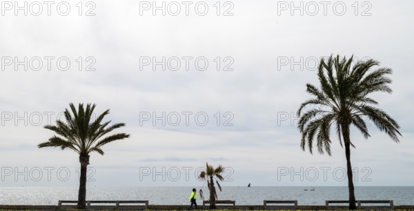 View of the sea and pedestrians from the seafront road Ma-19, Avenida de Gabrial Roca, Autopista de