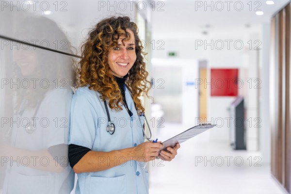 Happy nurse looking at camera and smiling while working in the hospital