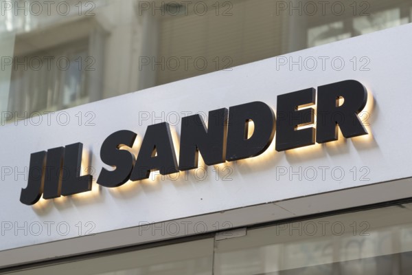 Close-up, logo of the German luxury fashion brand Jil Sander on a boutique in the shopping street