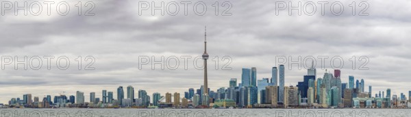 A panorama picture of the Toronto Skyline on a cloudy day taken from the islands across