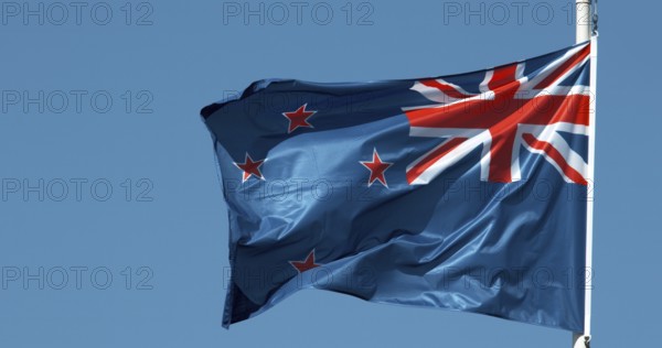 New Zealand Flag Waving in the Wind against blue sky