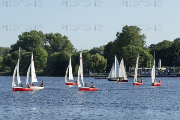 Symbolic picture weather, leisure activities in summer, sailing school, sailing boats in front of a