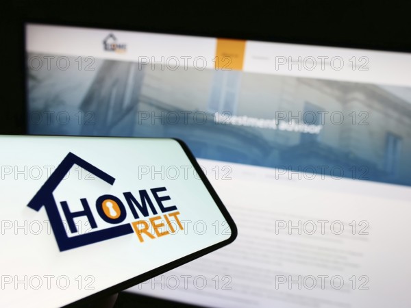 Stuttgart, Germany, 01-11-2023: Mobile phone with logo of British real estate company Home REIT plc