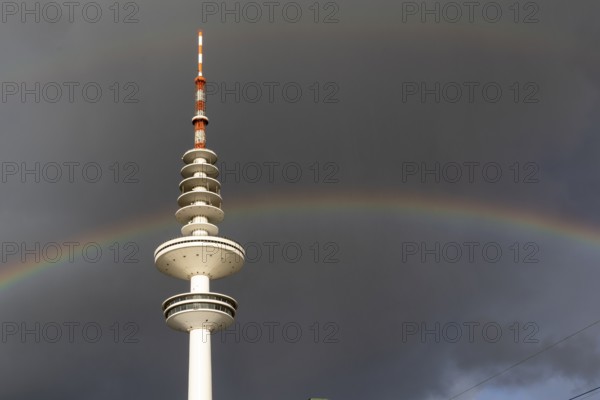 Weather symbol, Telemichel TV tower in front of a dramatic stormy sky with rainbow, Hamburg,
