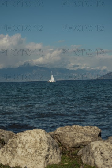 A sailing boat on Lake Garda in the sunshine, Sirmione, Lake Garda, Italy, Europe