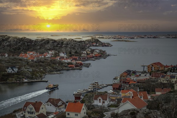 Beautiful typical Scandinavian village that winds around a coastal strip in a bay. Wintery