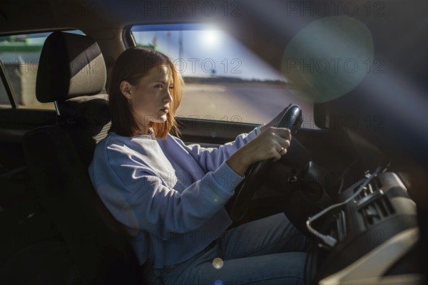 Young beautiful woman driver driving a car, happy trip, spring travel