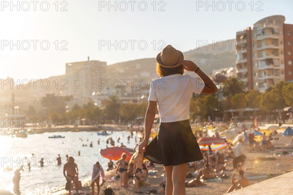 Portrait of a tourist woman in the sunset of Sarande or Saranda in the Albanian riviera walking