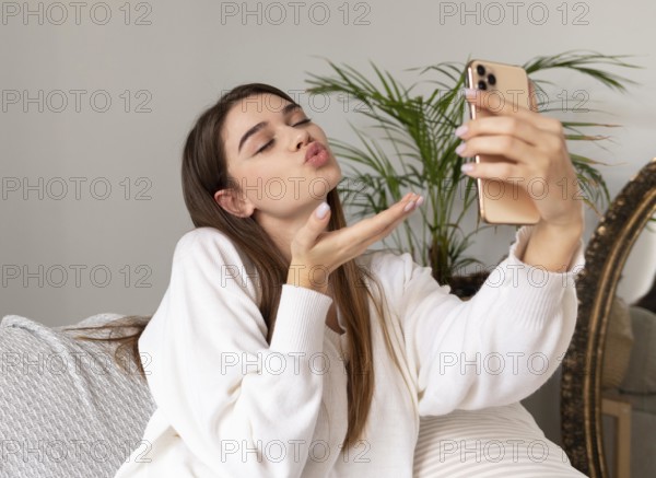 Woman with mobile taking selfie