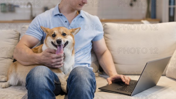 Front view man working while holding dog