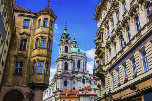 Historic architecture of downtown Prague, Czech Republic. Mostecka Street with St Nicholas Bell