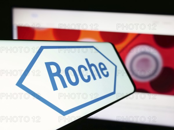 Stuttgart, Germany, 11-16-2023: Smartphone with logo of Swiss healthcare company Roche Holding AG