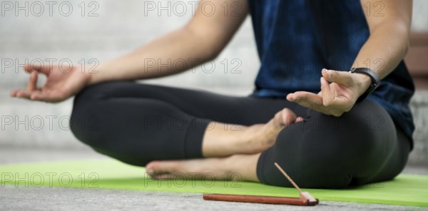 Man lotus position practicing yoga