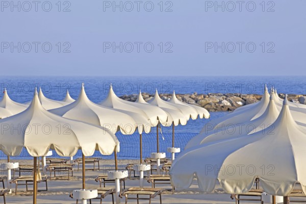 Parasols and beach chairs, beach, seaside resort of Arma di Taggia, province of Imperia, Liguria,