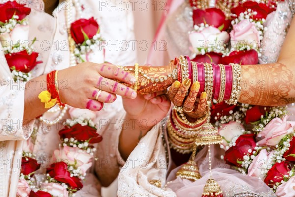Indian groom passing bangles on his brides hand on her wedding ceremony, Mauritius, Africa