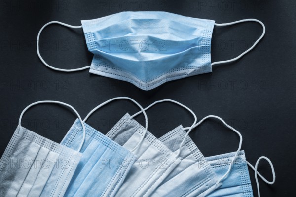 Disposable respiratory medical masks on black background