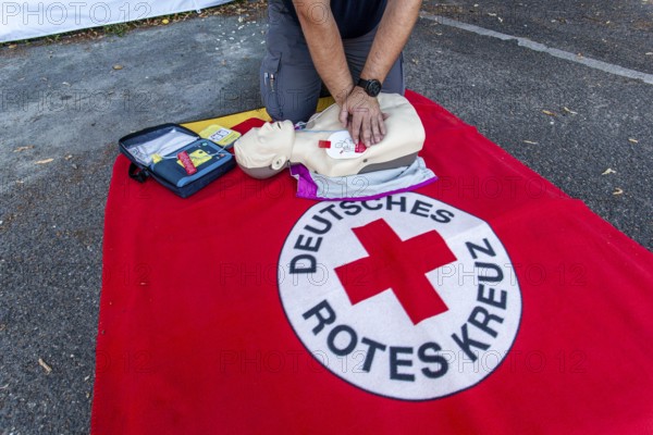 DRK (German Red Cross) staff demonstrating how to use an AED (automated external defibrillator) or
