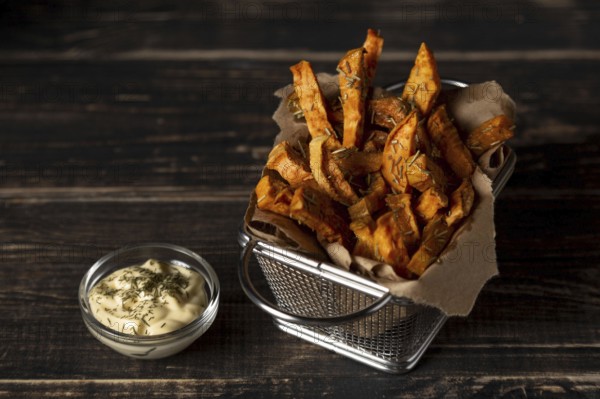 High angle sweet potato fries with sauce