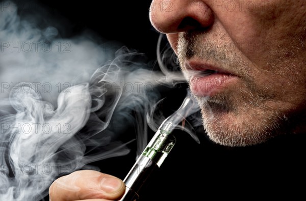 Close up portrait of a man smoking an e-cigarette